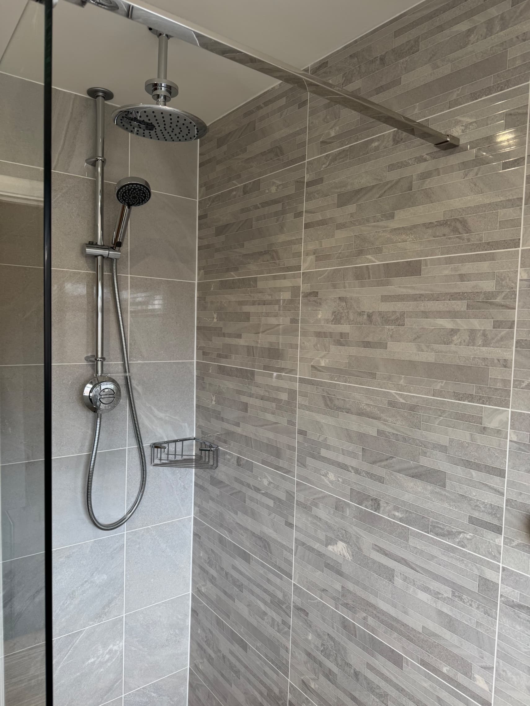 We've finished grouting the tiles in this Wokingham bathroom and fitted the shower head and screen — the job's now complete and ready for use.