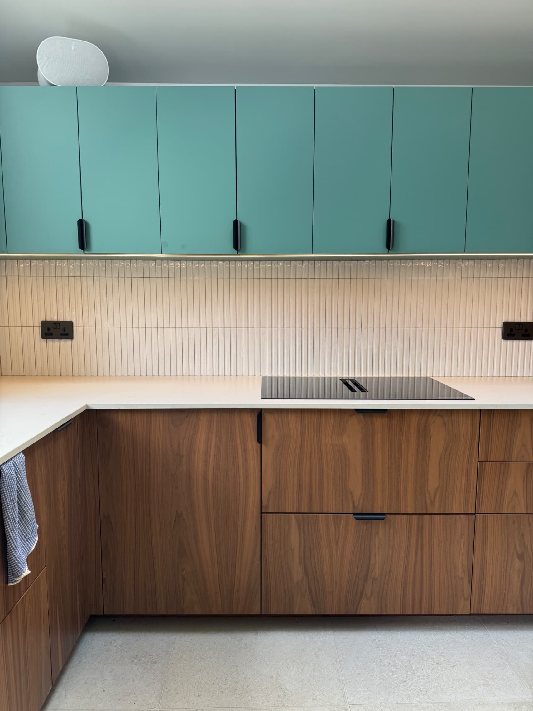 We've now finished tiling and grouting the splashback in Twyford. The vertical tile layout gives a clean, modern look, and we've worked around the existing sockets neatly so everything sits flush and professional.