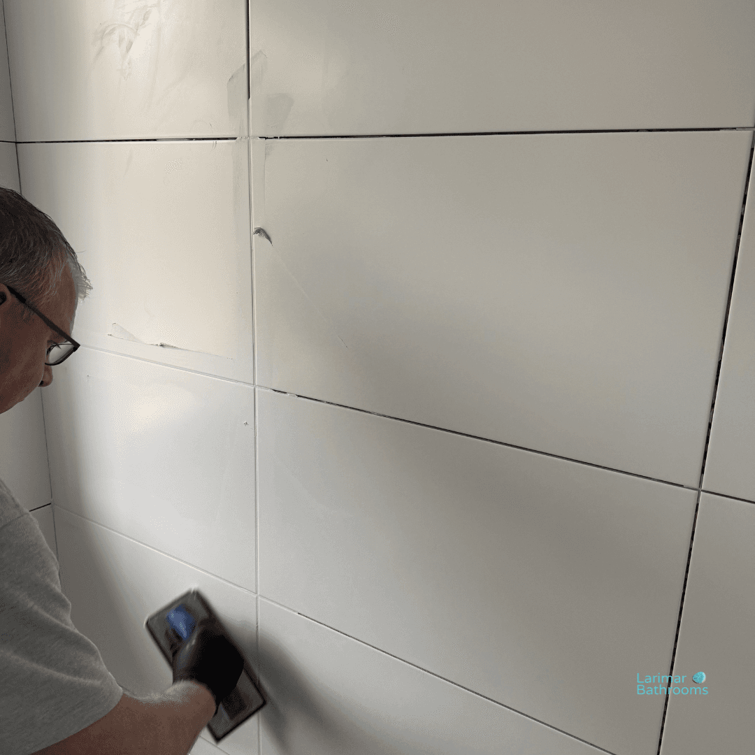 Grouting commences on the wall tiles.
