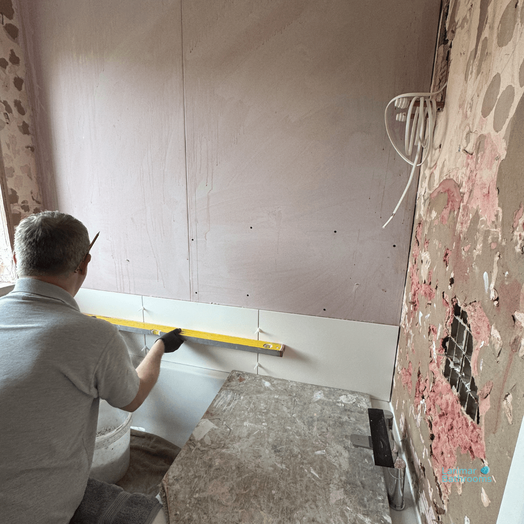 Tiling has commenced on the bath wall.